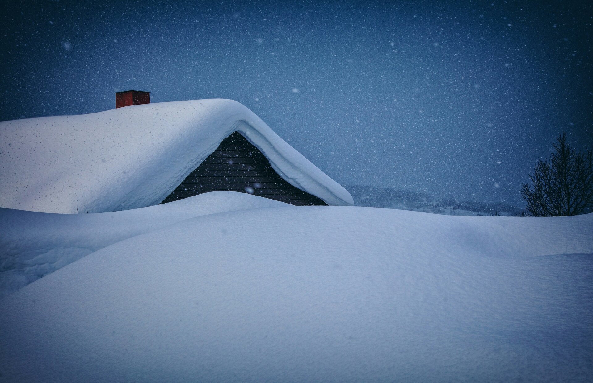 Das Bild zeigt eine Scheelandschaft, aus der ein schneebedecktes Dach herausragt | © Vidar Nordli-Mathisen / Unsplash